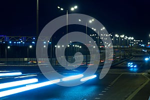 Highway traffic cars at night blured. Cars moving on road on bridge evening blurry.