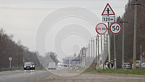 Highway traffic with road signs. Crossroads, speed limit, no overtaking. Road in the countryside with a no overtaking
