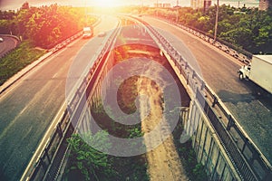 Highway tragic at sunset, big urban city bridges