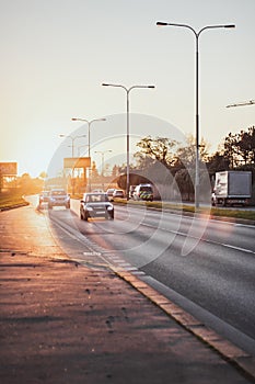 Highway transportation with cars and Truck at sunset