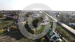 Highway traverses rural landscape with church and houses