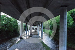 Highway underpass from concrete with small river