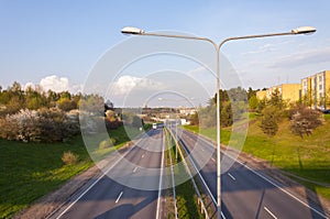 Highway view from the bridge with double street lanterns and cityscape view of Vilnius Lithuania on background