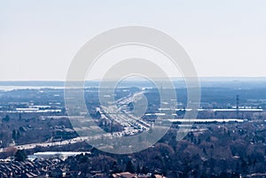 Highway winding and receding into white hazy distance.