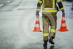 Highway Worker Preparing For Road Closure Moving Two Traffic Cones photo