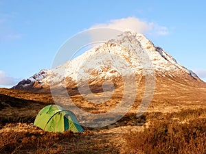 Higland in Scotland. Marvelous day at frozen river Coupall at delta to river Etive. Snowy cone of mountain photo