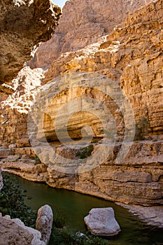 Hike through narrow valley of Wadi Shab in Tiwi near Mascat in Oman photo