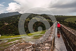 Hike over an old bridge with rainwater in the middle of a natural landscape in Tepotzotlan, Mexico photo