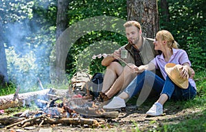 Hike picnic. Couple take break to eat nature background. Couple in love camping forest hike. Couple sit near bonfire eat