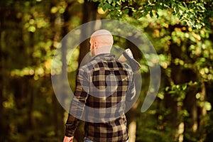 Hike vacation. Hike in forest. Forest care. Determination of human spirit. Man checkered shirt use axe. Brutal male in