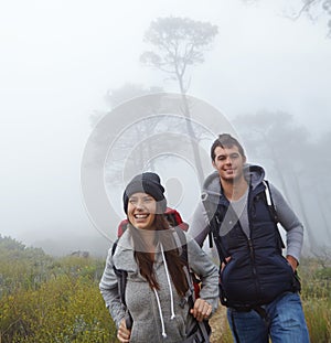 This hike was the best idea ever. a young couple enjoying a hike through nature.