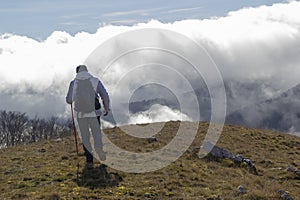 Hiker above the clouds