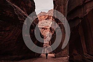 Hiker Admires Red Cliff Walls of Bucksin Gulch