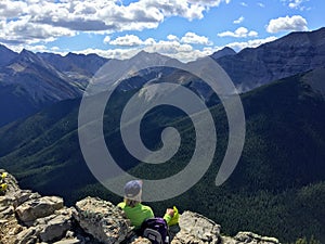 A hiker admiring the glorious view of the Rocky Mountains after completing the Sulphur Skyline Trail outside of Jasper National Pa