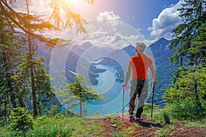 Hiker in the Alps. Backpacker tourist hiking at Lake.