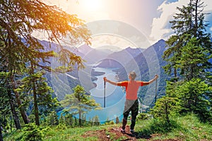 Hiker in the Alps. Backpacker tourist hiking at Lake.