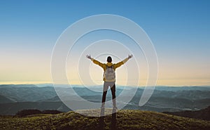 Hiker with arms up standing on the top of the mountain - Successful man enjoying triumph