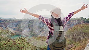 Hiker Asian backpacker woman walking to top of mountain, Female enjoy her holidays on hiking adventure feeling freedom. Lifestyle