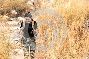 Hiker asian woman backpack walking trail activity camping outdoors for destination leisure.