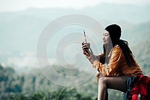 Hiker asian woman sitting and drinking coffee for relax and rest on mountain. Female adventure backpack and trips camping on hike