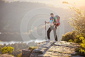 Hiker with baby standing on cliff