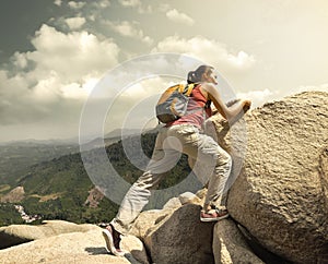 Hiker with backpack crossing rocky terrain