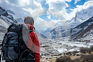 hiker with a backpack gazing at a snowladen valley