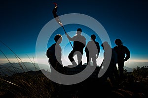 Hiker with backpack standing on top of a mountain