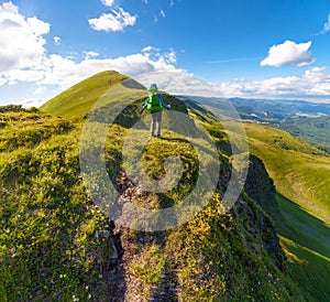 Hiker with backpack standing on top of the mountain in Carpathians. Ukraine. Svydovets ridge