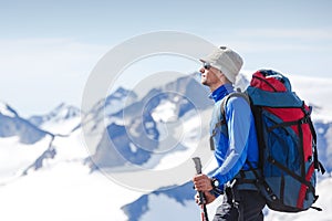 Hiker with backpack standing on top