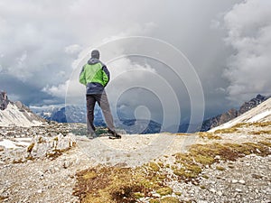 Hiker with backpack traveling in spring Dolomiti