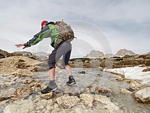 Hiker with backpack traveling in spring Dolomiti