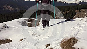 Hiker With Backpack Walking On A Mountain Ridge, Covered With Deep Snow