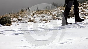 Hiker With Backpack Walking On A Mountain Ridge, Covered With Deep Snow