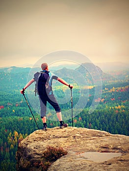 Hiker backpacker reaches the summit of mountain peak. Success, freedom and happiness