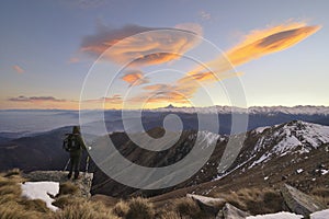 Hiker with backpacking observes the Alps