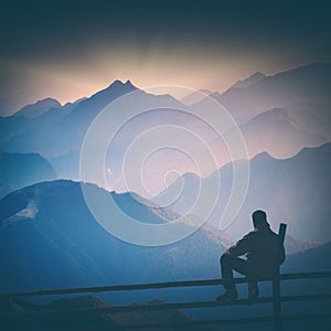 Hiker and blue morning fog. Instagram stylisation