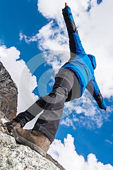 Hiker catching balance on mountain ridge