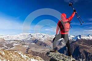 Hiker celebrates the conquest of the summit. Concepts: victory,