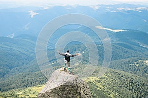 hiker celebrating success on top of a mountain