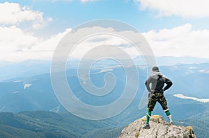 hiker celebrating success on top of a mountain