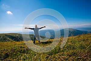 Hiker celebrating success on top of a mountain