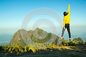 Hiker celebrating success on top of a mountain