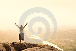 Hiker celebrating success while traveling in the mountains