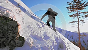 Hiker climbing mountain in winter season