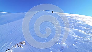 Hiker climbing mountain in winter season