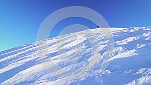 Hiker climbing mountain in winter season