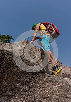 Hiker climbing on a rock