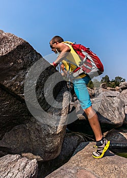 Hiker climbing on a rock