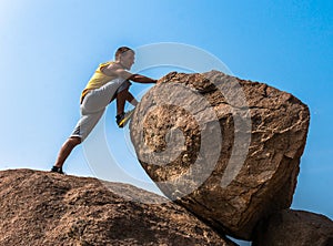 Hiker climbing on a rock